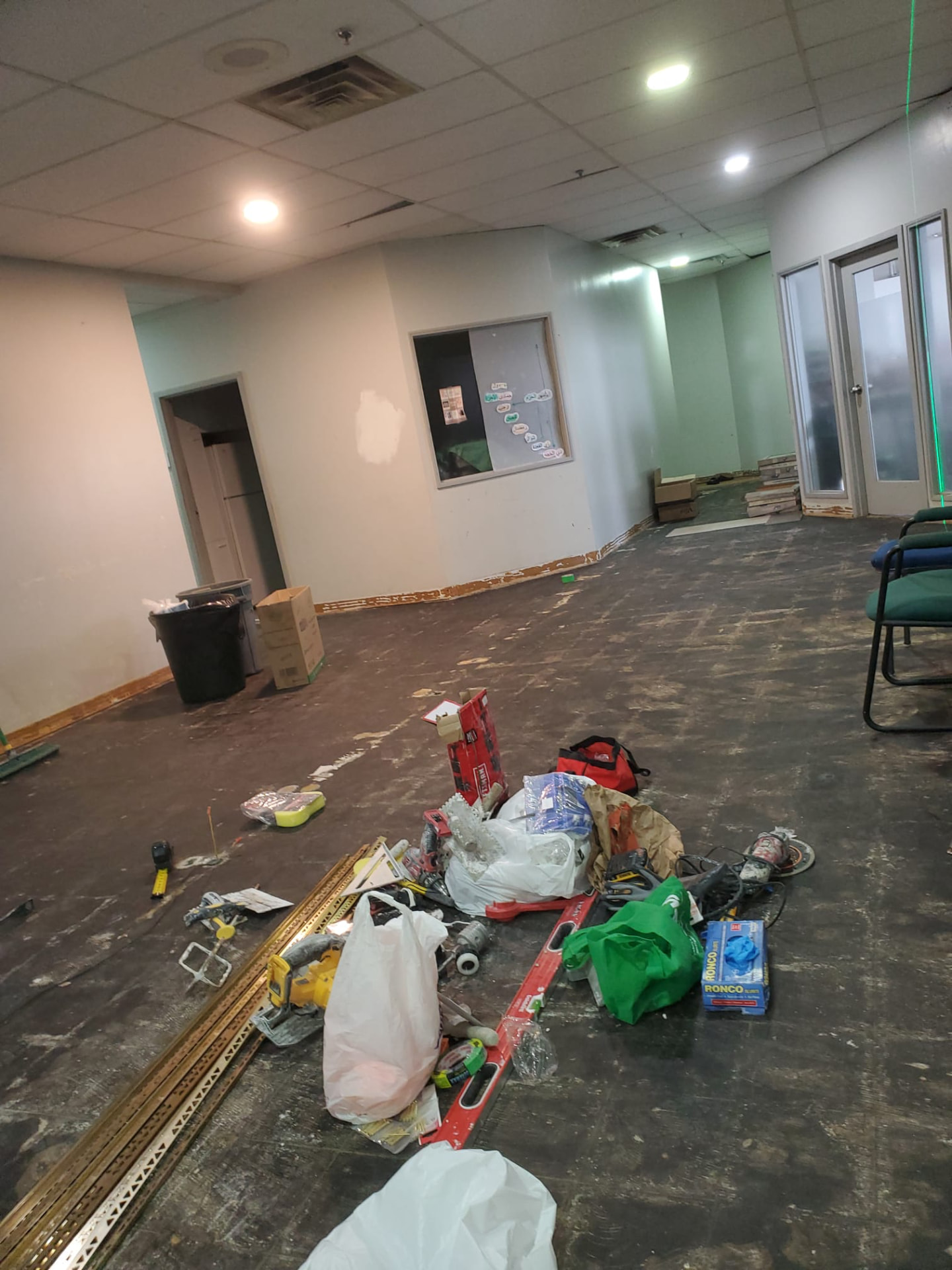 Large interior space stripped back with tools laid out during flooring work