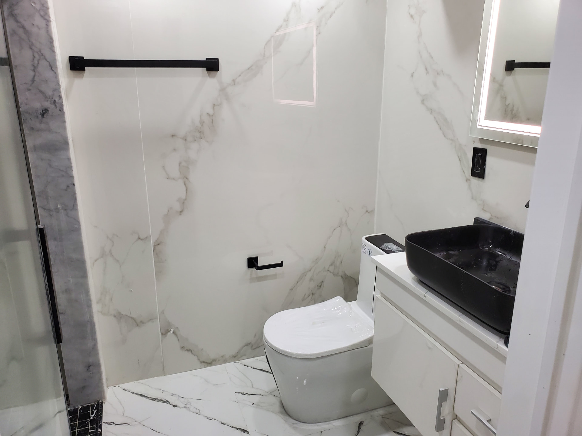 Full view of the finished bathroom with glass shower