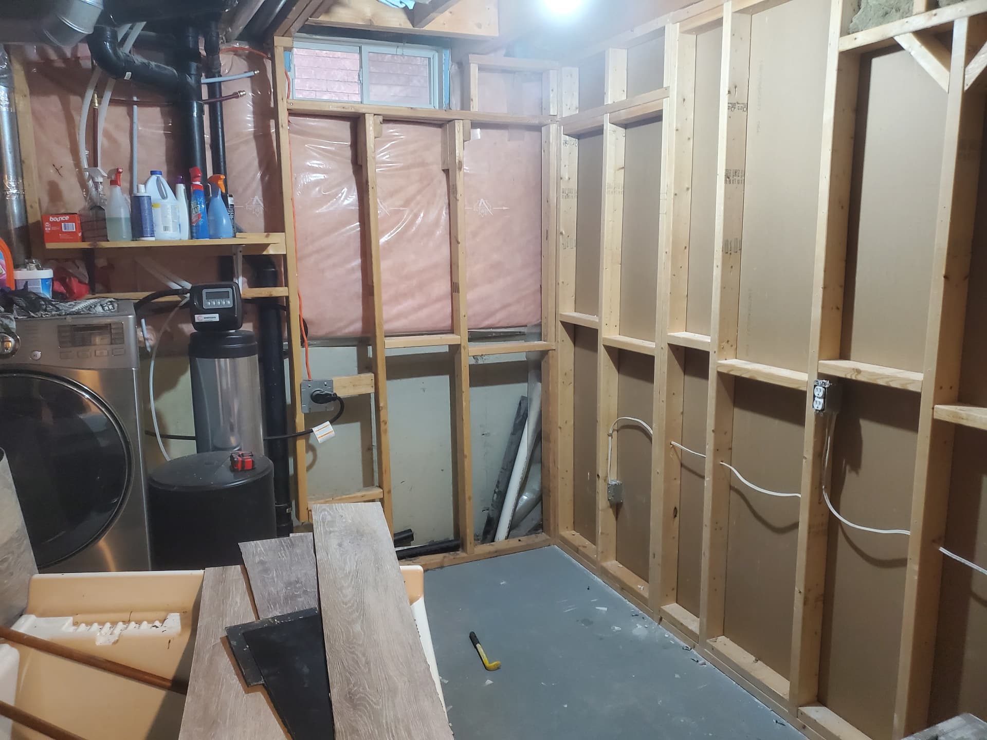 Basement stripped back with new stud framing and utilities exposed