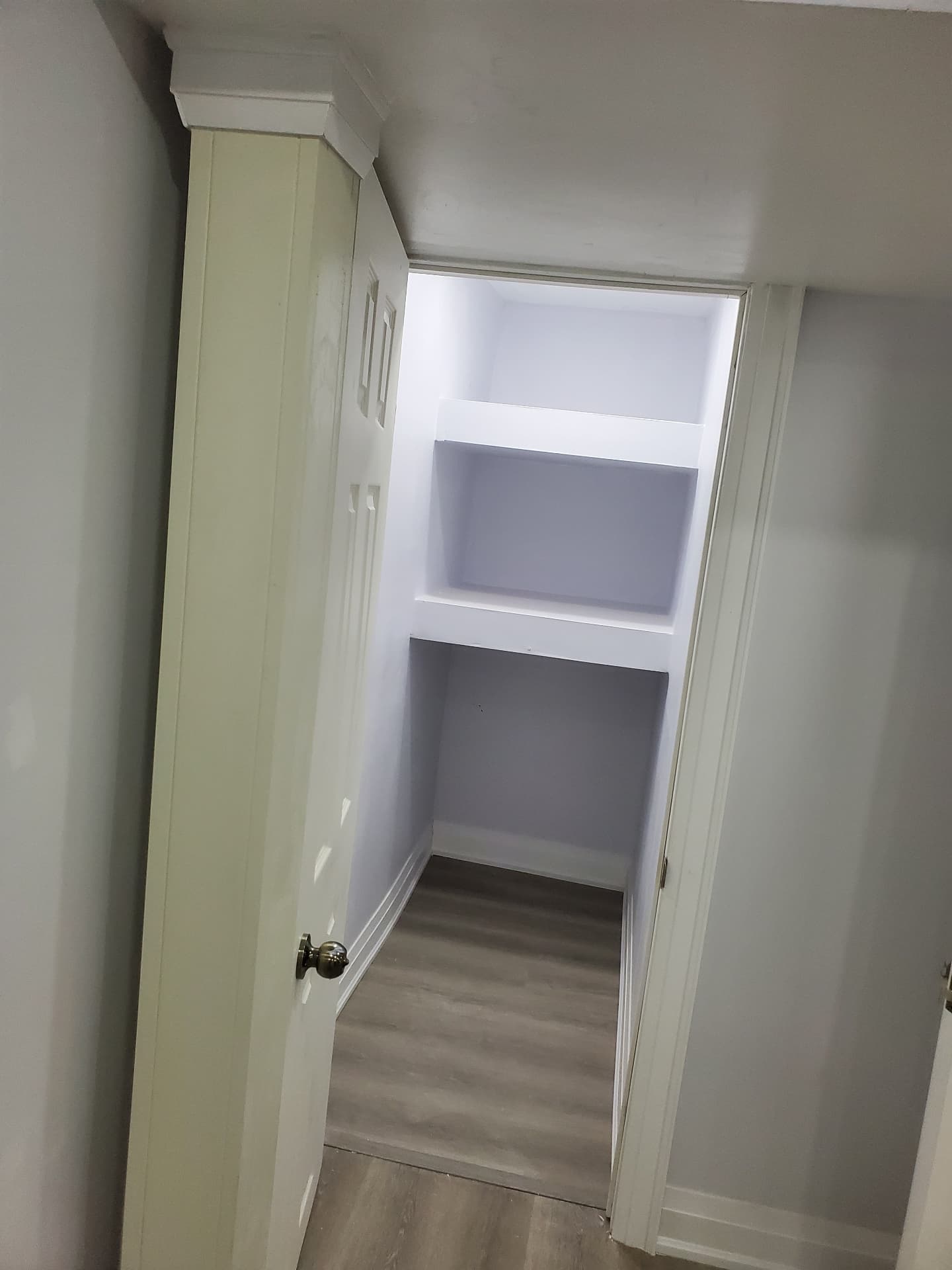 Finished storage closet with built-in shelving
